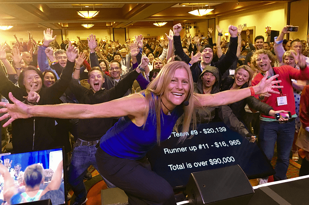 Woman in blue tank top with group in background