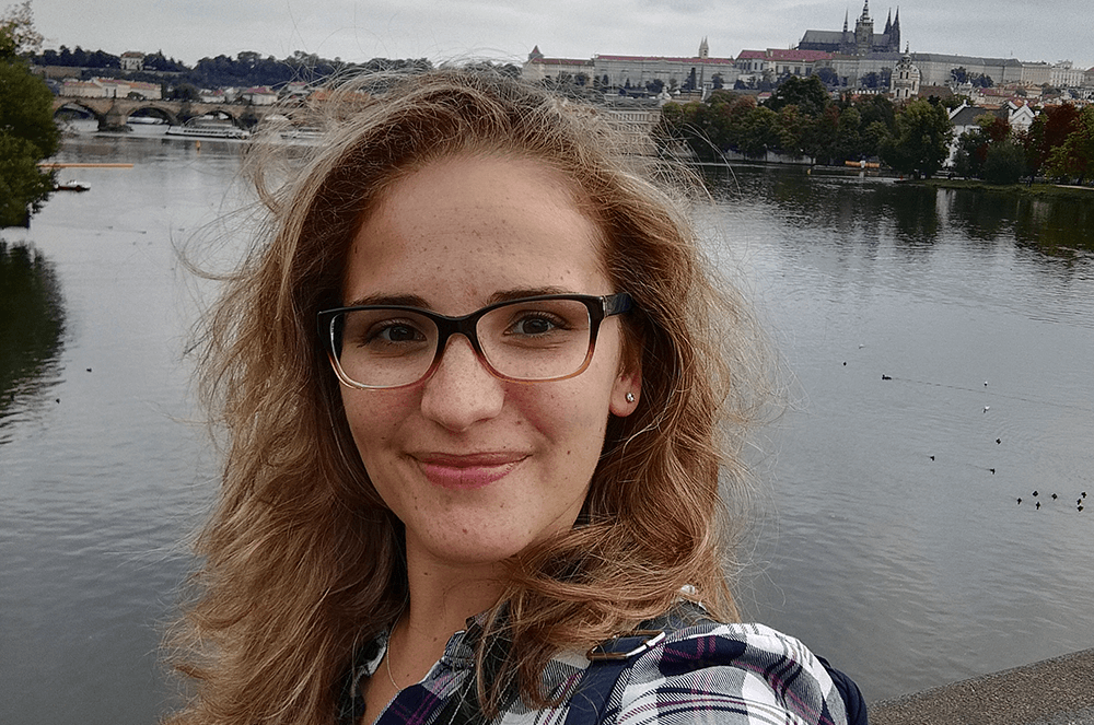 Woman posing by water