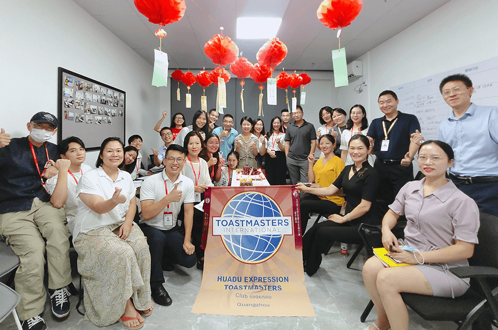 Group posing around banner